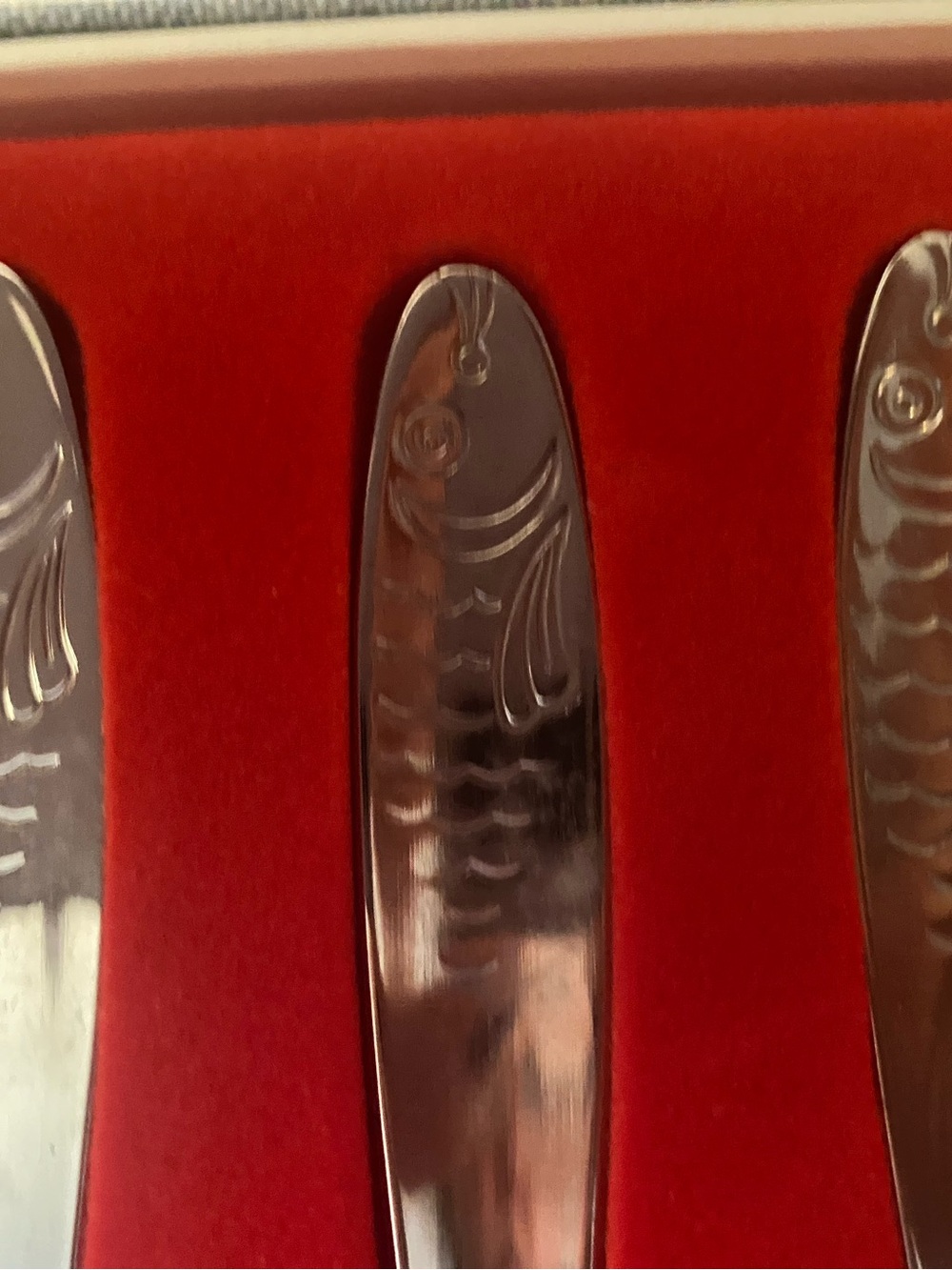 Silver Stainless Steel Fish-Engraved Flatware Knife Set on Blue Placemat - Picture 8 of 8